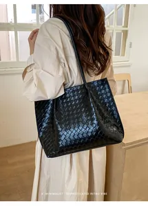 Gros plan sur la texture en cuir tressé noir d'un grand sac cabas minimaliste