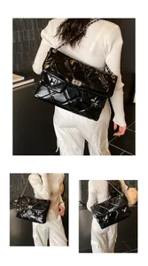 Detailed close-up showing the glossy quilted leather texture and silver chain strap of the bag