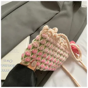 Detail of hand-woven cream bucket bag with 3D tulip patterns and pearl buckle