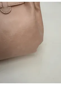 Detail shot of pink soft leather tote bag showing fine stitching and smooth hardware