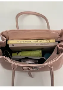 Top view of pink leather tote bag interior showing large capacity for books and umbrella