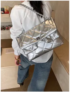 Silver quilted chain bag with metallic finish and dual front pockets for daily style