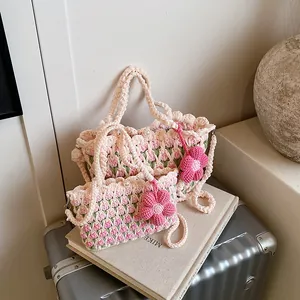 Handmade crochet tulip tote bag and mini crossbody bag set on silver suitcase