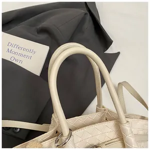 Détail du sac seau en cuir tressé crème avec artisanat Intrecciato et anneau en argent