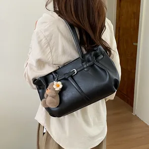 Black leather tote bag for women with cute bear charm and minimalist shoulder straps