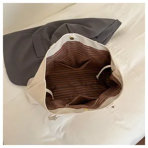 Top view of large tote bag interior showing brown striped lining and magnetic closure