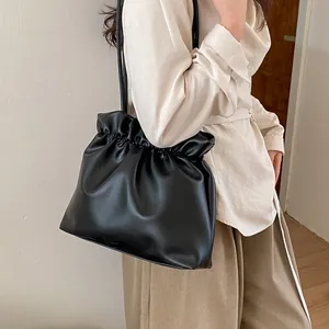 Minimalist black PU leather bucket bag with drawstring closure and slim shoulder straps
