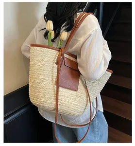 Detail of straw tote bag with brown leather trim and large capacity for beach vacation