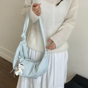 Minimalist light blue crescent shoulder bag with knot strap and small horse charm