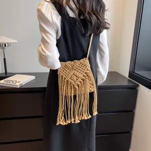 Bohemian handwoven straw crossbody bag with geometric patterns and long fringes