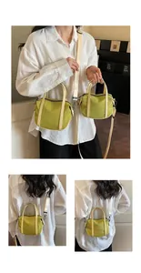 Detail view of olive green nylon tote bags with off-white straps in two sizes