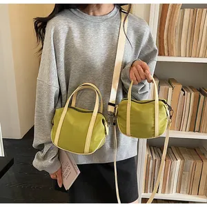 Avocado green canvas handbag set with adjustable straps shown in daily use scene