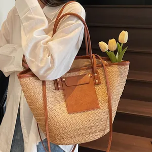 Large capacity straw woven tote bag with brown leather accents and rivet details