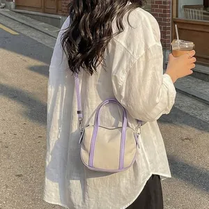 Minimalist beige and lavender crossbody bag with dual handles for daily casual use