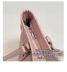 Detail of pink leather tote bag with premium silver metal zipper and striped lining