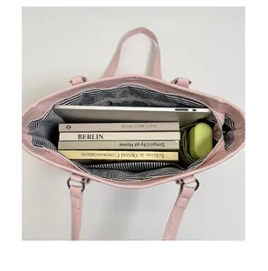 Top view of pink tote bag showing large capacity for laptop, books, and striped lining