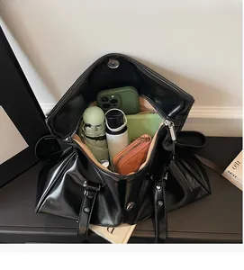 Detailed top view showing the spacious interior of the large black tote bag with items