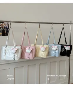 Row of minimalist large tote bags in five pastel colors hanging on a metal rack