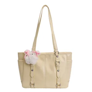 Chic beige tote bag with litchi texture and a cute plush bunny charm for daily commute