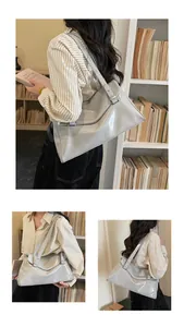 Detailed view of light gray glossy tote bag with sleek texture and long shoulder straps