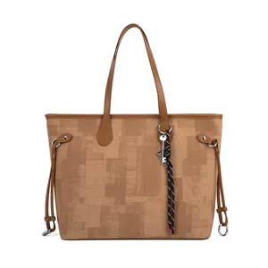 Large capacity brown tote bag with geometric print and decorative charm on white background