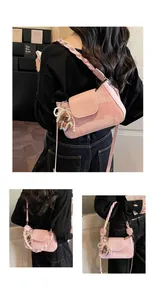 Detail of pink vintage shoulder bag with canvas body, woven handle and cute bear charm