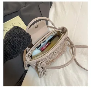 Detail view showing internal capacity of the beige pleated bucket bag with magnetic closure