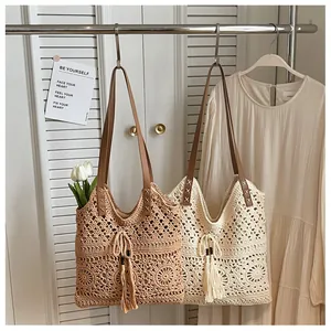 Detail of crochet tote bags with floral hollow patterns and brown leather straps