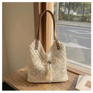 Close-up of crochet cotton tote bag with floral pattern and stitched leather shoulder strap