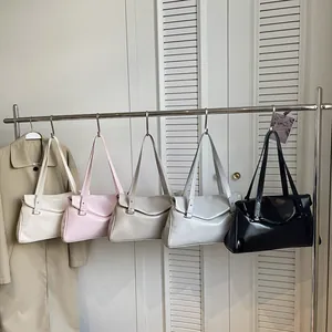 Minimalist patent leather tote bags in five colors hanging for a stylish look