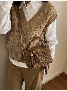 Brown pleated leather bucket bag with fringe tassels and detachable shoulder strap