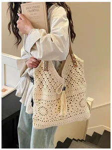 Close-up of beige crochet tote bag featuring intricate floral patterns and leather straps