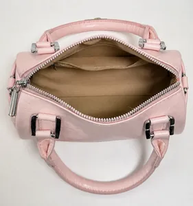 Top view of pink leather barrel bag showing spacious main compartment and zipper pocket