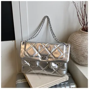 Macro shot of silver metallic quilted handbag with chain strap and dual front pockets