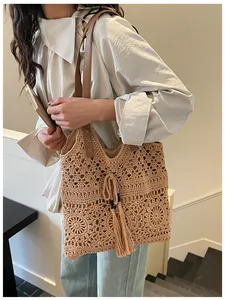 Close-up of hollow cotton weave pattern with brown leather strap and tassel detail