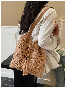 Detail of hand-woven crochet tote bag with flower patterns and leather straps