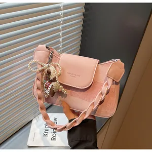 Pink PU leather shoulder bag featuring woven texture and a cute sheep pendant detail