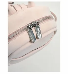Detail of pink leather mini backpack with custom silver hardware and dual zippers