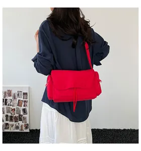 Borsa a tracolla in tela rossa con dettagli zip e tracolla larga su modella