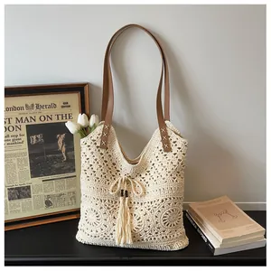 Detailed view of the hollow mesh crochet tote bag with wooden beads and leather straps