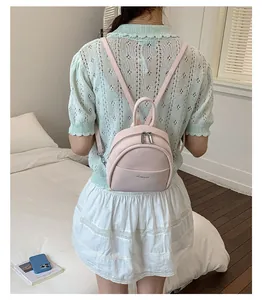 Mini pink backpack for women featuring a minimalist design and adjustable shoulder straps