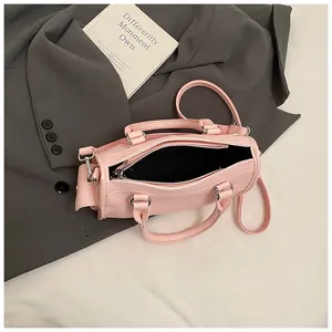 Detail of pink lychee textured leather Boston bag with zipper and slim shoulder strap