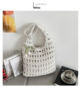 Detail of white hollow crochet tote bag with tulip pendant and mesh texture