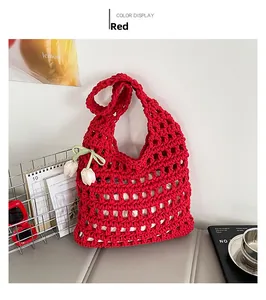 Detailed grid weave of the red hollow tote bag with a white tulip charm and green bow