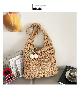 Detail of khaki woven tote bag featuring hollow mesh structure and tulip pendant decoration