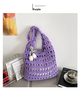 Detail of purple hollow knit hobo bag with floral charms in a French aesthetic setting