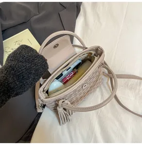 Interior view of beige woven bucket bag showing space for phone, lipstick, and cosmetics