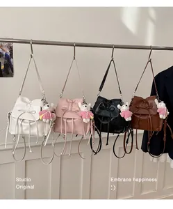 Detail view of mini PU leather backpacks in four colors with bows and bear charms