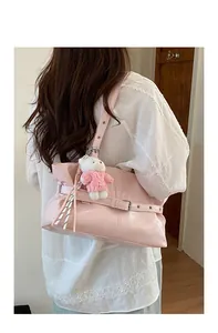 Detail of pink PU leather tote bag with pleated design and cute white bear keychain