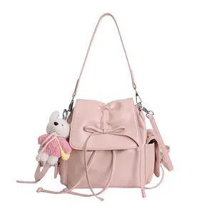 Pink PU leather backpack with bow detail and cute bunny plush charm for daily use